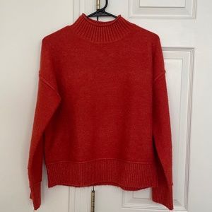 Orange turtleneck sweater